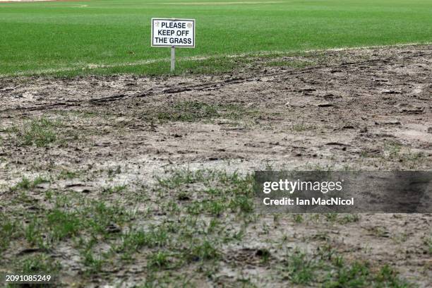 Please keep of the grass sign " is seen as the Dundee vs Rangers match is called off due to the condition of the pitch during the Cinch Scottish...