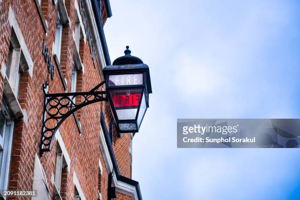 traditional red lantern in front of a fire station in fulham, london at night, uk - street light lamp stock pictures, royalty-free photos & images