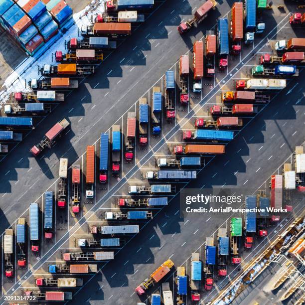 aerial view, rows of trucks driving in harbor with trailers - lastbilstransport bildbanksfoton och bilder