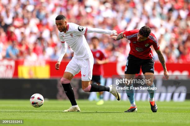 Yousseff En-Nesyri of Sevilla FC is challenged by Unai Nunez of Celta Vigo during the LaLiga EA Sports match between Sevilla FC and Celta Vigo at...