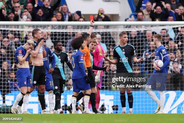 Referee Andy Madley shows a red card to Callum Doyle of Leicester City during the Emirates FA Cup Quarter Final between Chelsea FC and Leicester City...