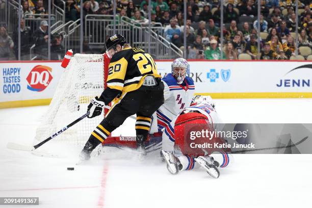 Lars Eller of the Pittsburgh Penguins attempts shot on goal against Jonathan Quick and Vincent Trocheck of the New York Rangers at PPG PAINTS Arena...