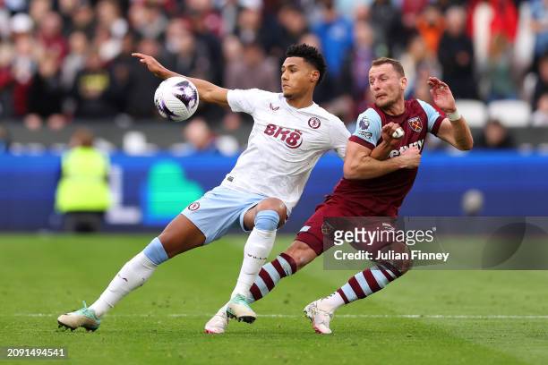 Ollie Watkins of Aston Villa is challenged by Vladimir Coufal of West Ham United during the Premier League match between West Ham United and Aston...