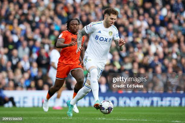 Joe Rodon of Leeds United is challenged by Michael Obafemi of Millwall during the Sky Bet Championship match between Leeds United and Millwall at...
