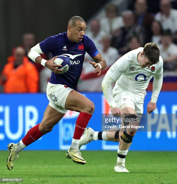 Gael Fickou of France breaks clear of Tommy Freeman during the Guinness Six Nations 2024 match between France and England at Groupama Stadium on...