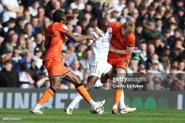 Glen Kamara of Leeds United battles for possession with Brooke Norton-Cuffy and Billy Mitchell of Millwall during the Sky Bet Championship match...