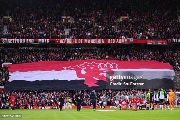 General view of the inside of the stadium as players of Manchester United and Liverpool line up, as fans of Manchester United raise a giant banner of...