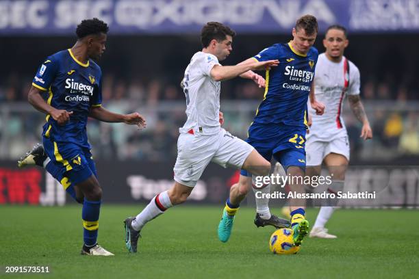 Christian Pulisic of AC Milan is challenged by Pawel Dawidowicz of Hellas Verona FC during the Serie A TIM match between Hellas Verona FC and AC...