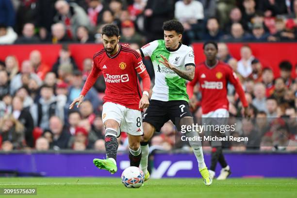 Bruno Fernandes of Manchester United passes the ball whilst under pressure from Luis Diaz of Liverpool during the Emirates FA Cup Quarter Final...