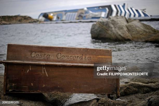Bench has ran aground near the cruise liner Costa Concordia liying aground in front of the Isola del Giglio on January 27, 2012 after hitting...