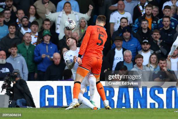 Joe Rodon of Leeds United is challenged by Jake Cooper of Millwall in the box during the Sky Bet Championship match between Leeds United and Millwall...