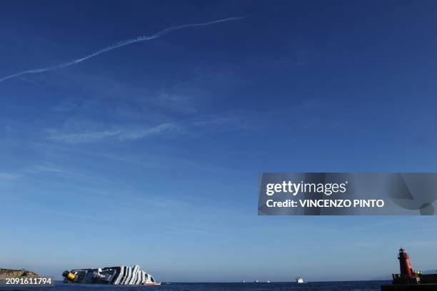 The cruise liner Costa Concordia lies aground on January 20, 2012 in front of the harbour of the Isola del Giglio after hitting underwater rocks on...