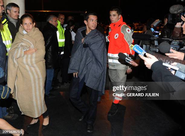 Italian cruise ship Concordia French survivors helped by French Red Cross employees, arrive in the port of the French southern city of Marseille on...