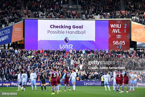 General view as the LED Screen displays the message "Checking Goal Possible Handball VAR" after Jarrod Bowen of West Ham United scored a goal, which...