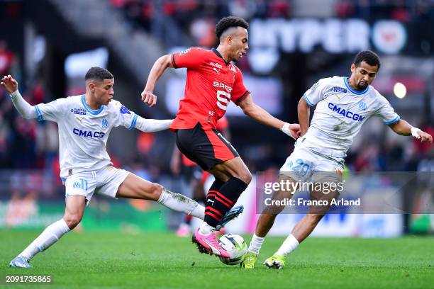 Guela Doue of Stade Rennais competes for the ball with Amine Harit and Iliman Ndiaye of Olympique de Marseille during the Ligue 1 Uber Eats match...