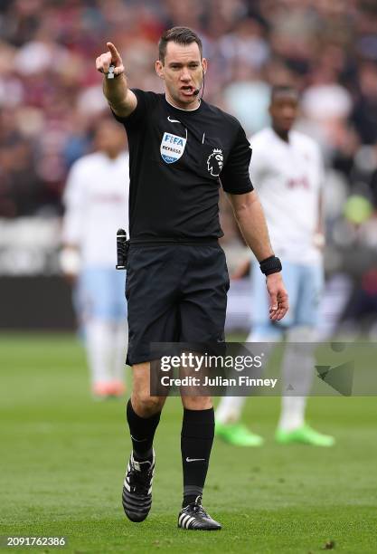 Referee Jarred Gillett looks on, during the Premier League match between West Ham United and Aston Villa at London Stadium on March 17, 2024 in...