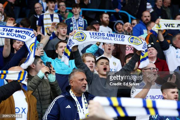 Leeds United fans celebrate with scarves after the team's victory during the Sky Bet Championship match between Leeds United and Millwall at Elland...