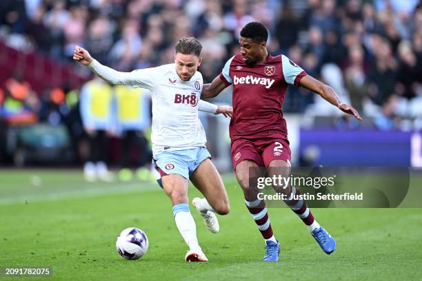 Matty Cash of Aston Villa and Ben Johnson of West Ham United compete for the ba during the Premier League match between West Ham United and Aston...