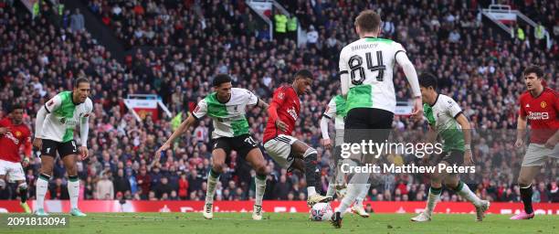 Marcus Rashford of Manchester United in action with Jarell Quansah of Liverpool during the Emirates FA Cup Quarter Final match between Manchester...