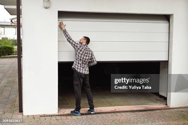 closing garage door. - closing door stock pictures, royalty-free photos & images