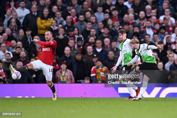 Harvey Elliott of Liverpool scores his team's third goal as Christian Eriksen of Manchester United fails to block the shot during the Emirates FA Cup...