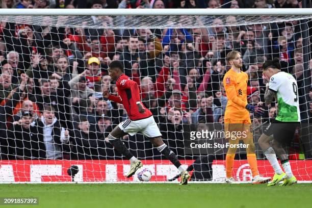 Marcus Rashford of Manchester United celebrates scoring his team's third goal as Caoimhin Kelleher of Liverpool reacts after failing to make a save...