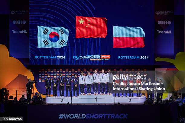 Team Korea, team China and team Poland pose in the Men's Relay medal ceremony during ISU World Short Track Speed Skating Championships 2024 at AHOY...