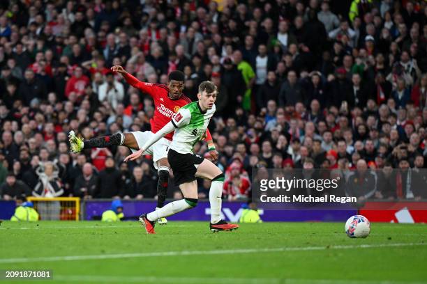 Amad Diallo of Manchester United scores his team's fourth goal whilst under pressure from Conor Bradley of Liverpool during the Emirates FA Cup...