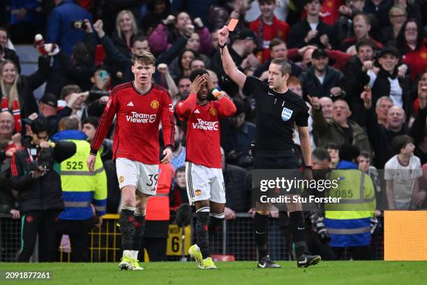 Referee John Brooks shows a red card to Amad Diallo of Manchester United, after he was shown a yellow card for removing his shirt during his...