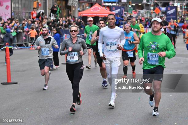 Amy Robach and T.J. Holmes participate in the United Airlines NYC Half Marathon on March 17, 2024 in New York City. The course starts in Brooklyn and...