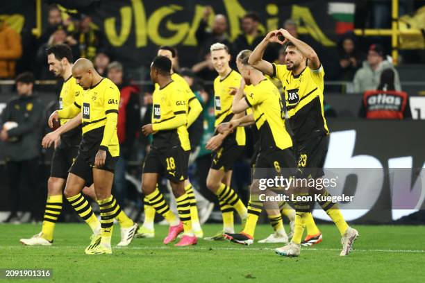 Emre Can of Borussia Dortmund celebrates scoring his team's third goal from the penalty spot with teammates during the Bundesliga match between...