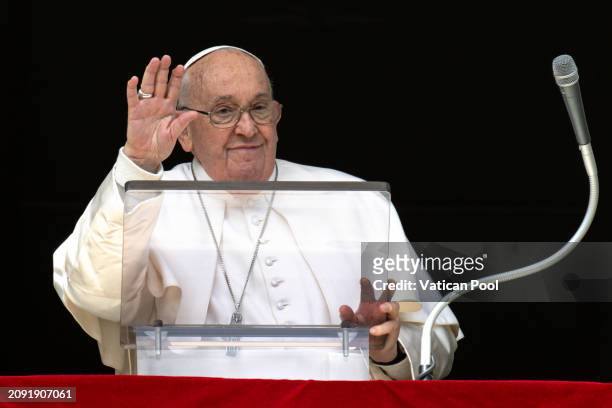 Pope Francis waves to the faithful as he delivers the Sunday Angelus blessing from his studio overlooking St. Peter's Square on March 17, 2024 in...