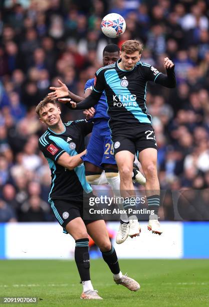 Kiernan Dewsbury-Hall of Leicester City wins a header over team mate Callum Doyle and Moises Caidedo of Chelsea during the Emirates FA Cup Quarter...