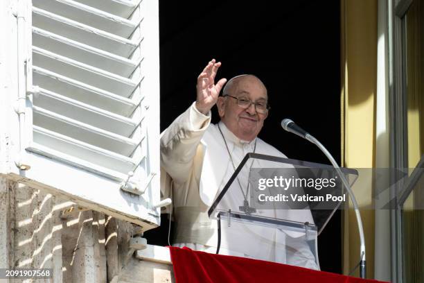 Pope Francis waves to the faithful as he delivers the Sunday Angelus blessing from his studio overlooking St. Peter's Square on March 17, 2024 in...