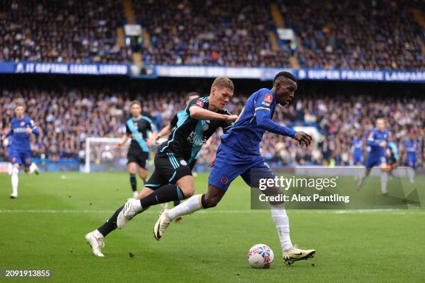 Nicolas Jackson of Chelsea is tackled by Jannik Vestergaard of Leicester City during the Emirates FA Cup Quarter Final between Chelsea FC v Leicester...