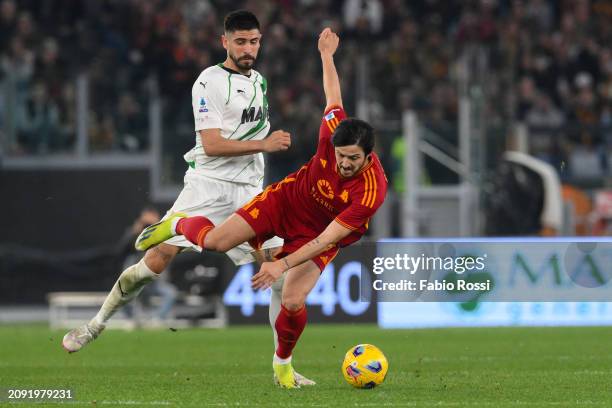 Sardar Azmoun of AS Roma is challenged by Erlic of US Sassuolo during the Serie A TIM match between AS Roma and US Sassuolo at Stadio Olimpico on...