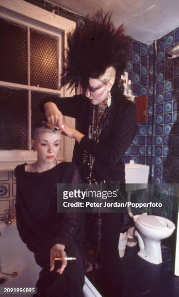 Punk having her head shaved in the toilet of a bed-sit in London, circa 1983.