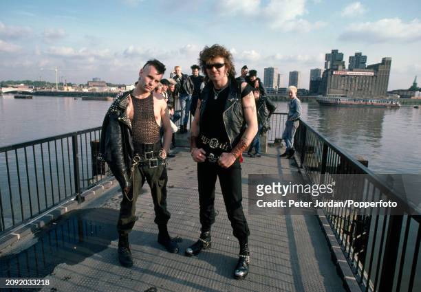 Group of Punks wearing biker jackets and studded belts beside the River Thames in London, circa 1983.