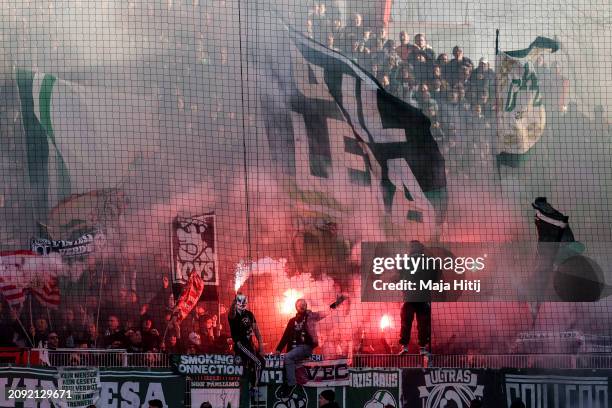 Fans of SV Werder Bremen burn fire during the Second Bundesliga match between Hertha BSC and FC Schalke 04 at Olympiastadion on March 17, 2024 in...