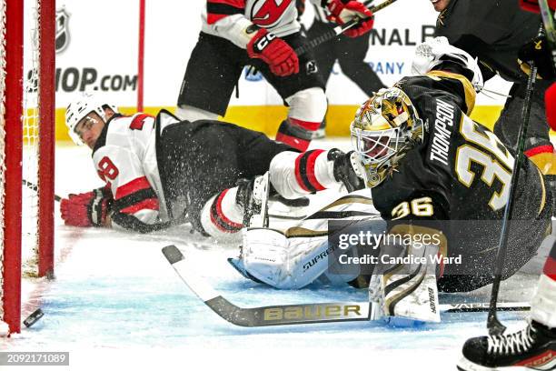 Logan Thompson of the Vegas Golden Knights watches the puck enter the net after colliding with Timo Meier of the New Jersey Devils at T-Mobile Arena...