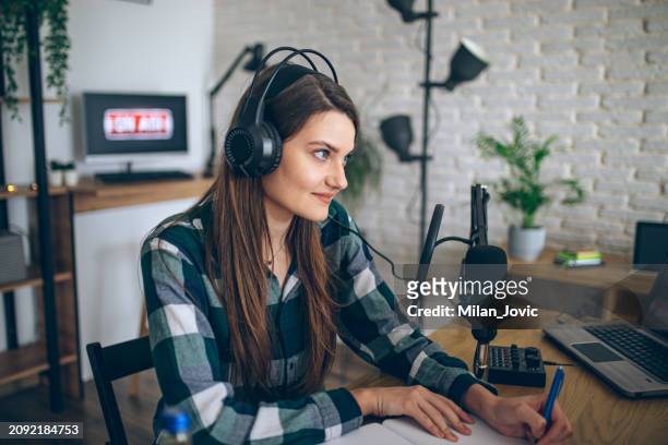 young woman recording a podcast - スポーツキャスター ストックフォトと画像