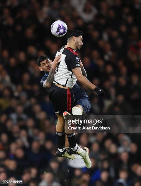 Cristian Romero of Tottenham Hotspur battles for possession with Raul Jimenez of Fulham during the Premier League match between Fulham FC and...