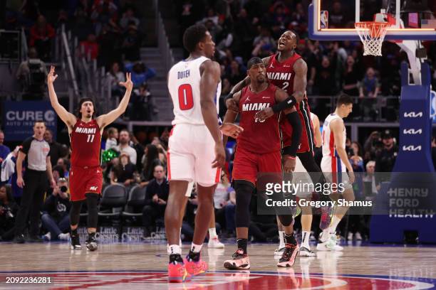 Bam Adebayo of the Miami Heat celebrates his game winning shot with Terry Rozier to beat the Detroit Pistons 104-101 at Little Caesars Arena on March...