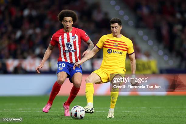 Robert Lewandowski of FC Barcelona is challenged by Axel Witsel of Atletico Madrid during the LaLiga EA Sports match between Atletico Madrid and FC...