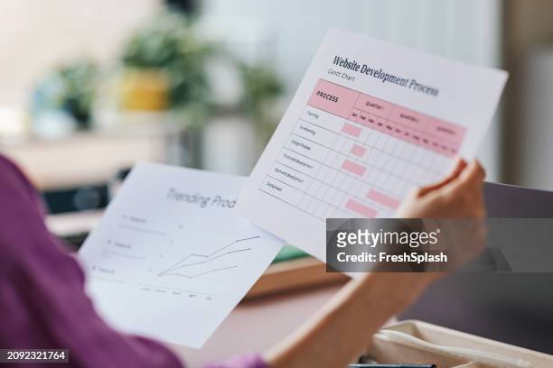 professional examining gantt chart for website development plan - strategy execution stock pictures, royalty-free photos & images