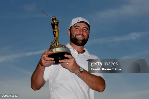 Scottie Scheffler of the United States poses with the trophy after winning THE PLAYERS Championship at TPC Sawgrass on March 17, 2024 in Ponte Vedra...