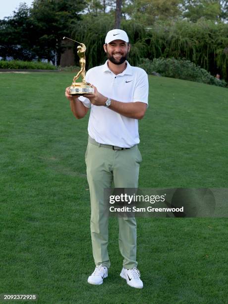 Scottie Scheffler of the United States poses with the trophy after winning THE PLAYERS Championship at TPC Sawgrass on March 17, 2024 in Ponte Vedra...