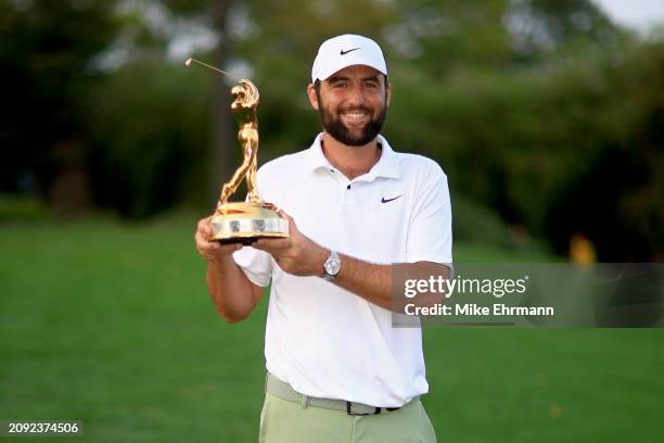 Scottie Scheffler of the United States poses with the trophy after winning THE PLAYERS Championship at TPC Sawgrass on March 17, 2024 in Ponte Vedra...