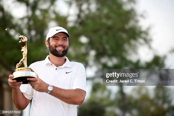 Scottie Scheffler of the United States poses with the trophy after winning THE PLAYERS Championship at TPC Sawgrass on March 17, 2024 in Ponte Vedra...
