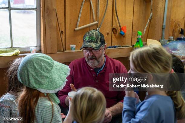 Local children listen to Pat LeClaire explain how maple syrup is made at his sugar house March 9, 2024 in Charlotte, Vermont. In 2023, LeClaire made...